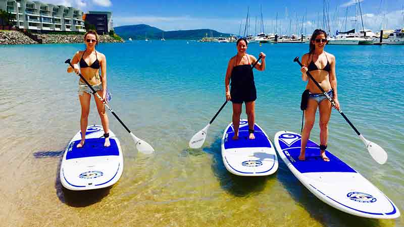 Hire a SUP and explore the beach at Airlie Beach