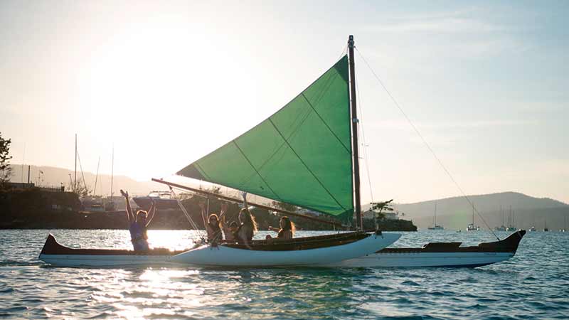 Join us for an unforgettable unique sunset over Airlie Beach in the only Hawaiian sailing outrigger canoe in Australia